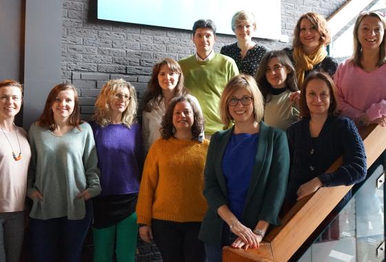 12 people, group photo around a staircase